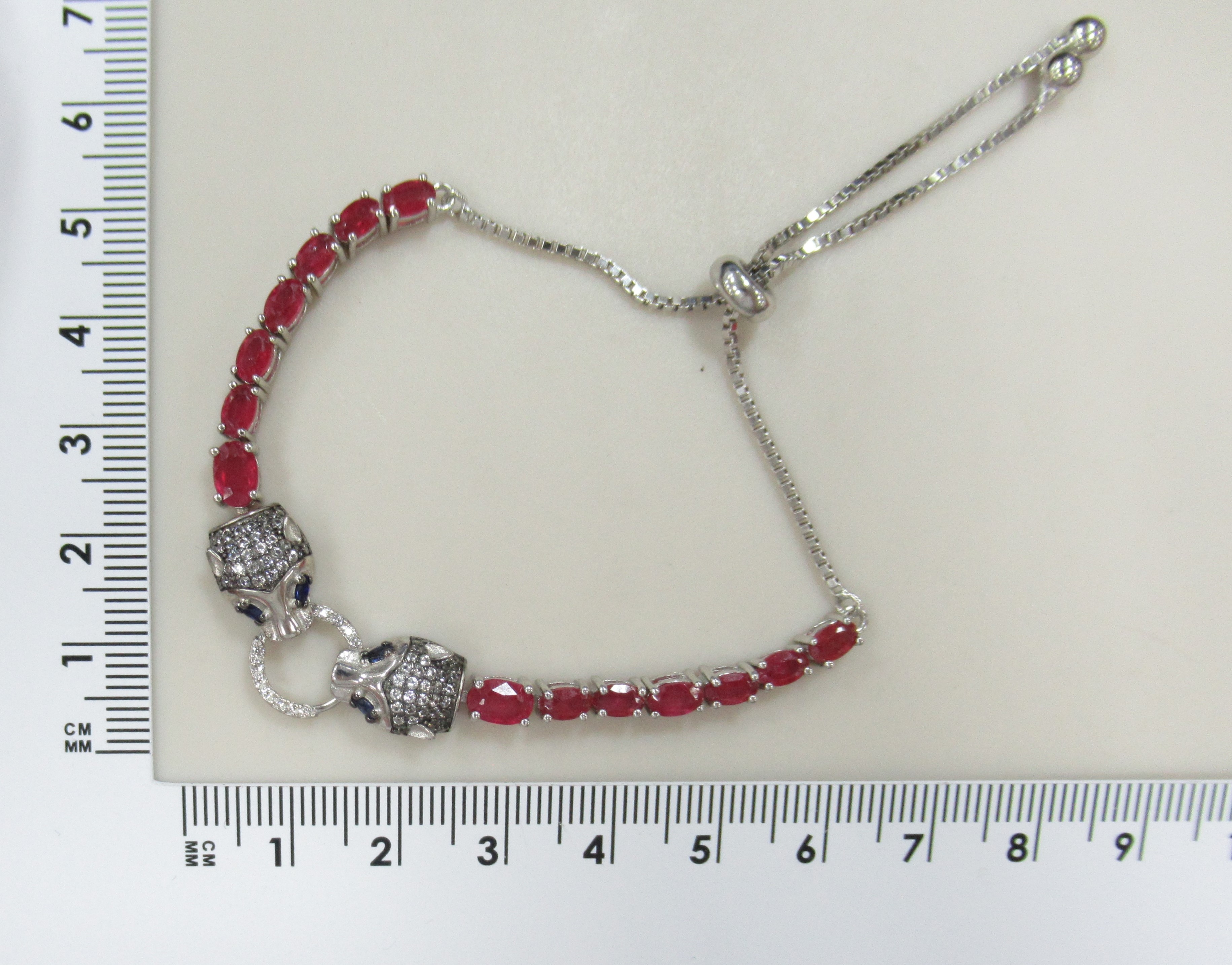 Серебряный браслет с рубинами и сапфирами "Пантеры"